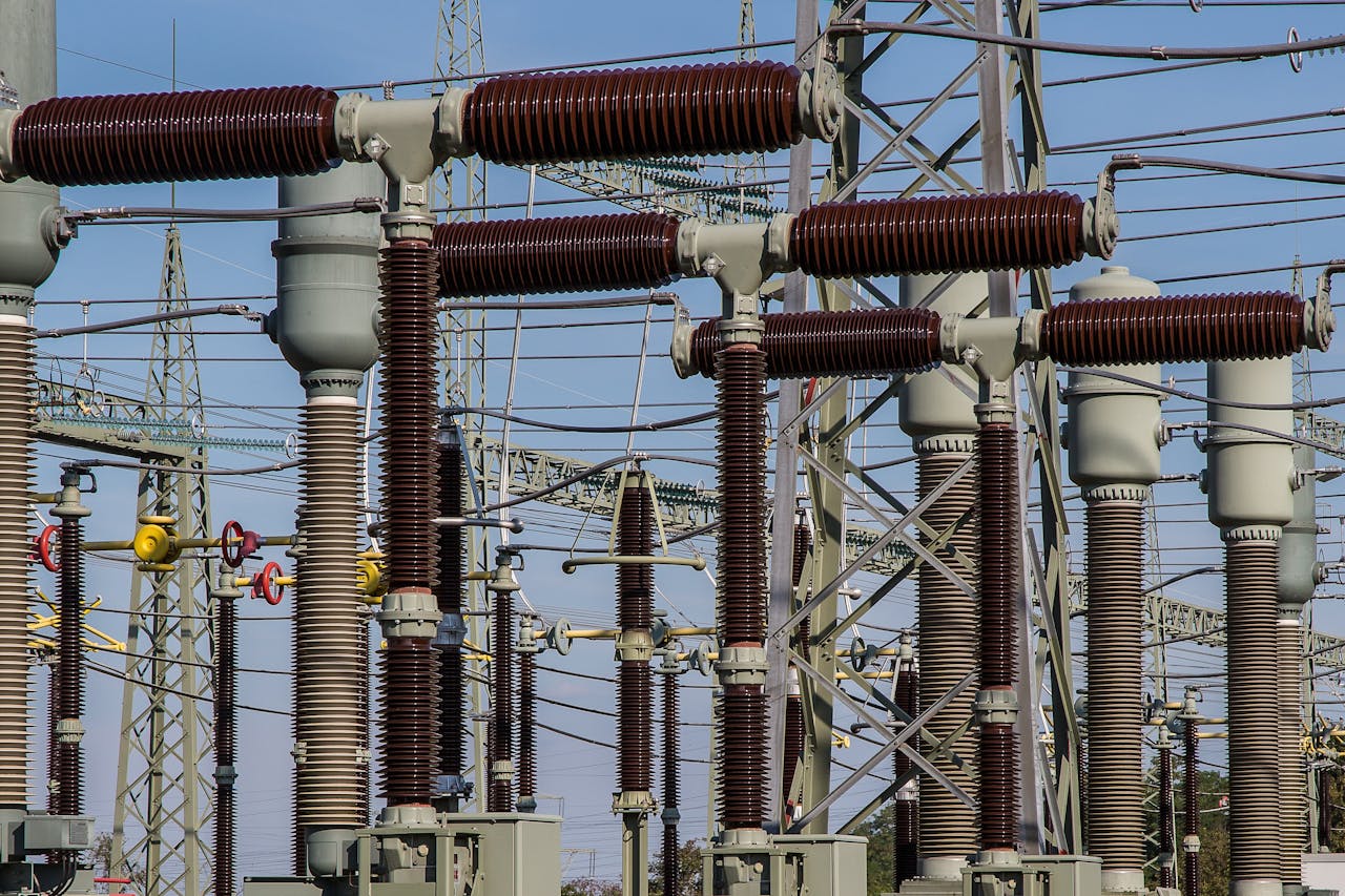 hero-img Detailed view of high voltage electrical substation with transformers and power lines.