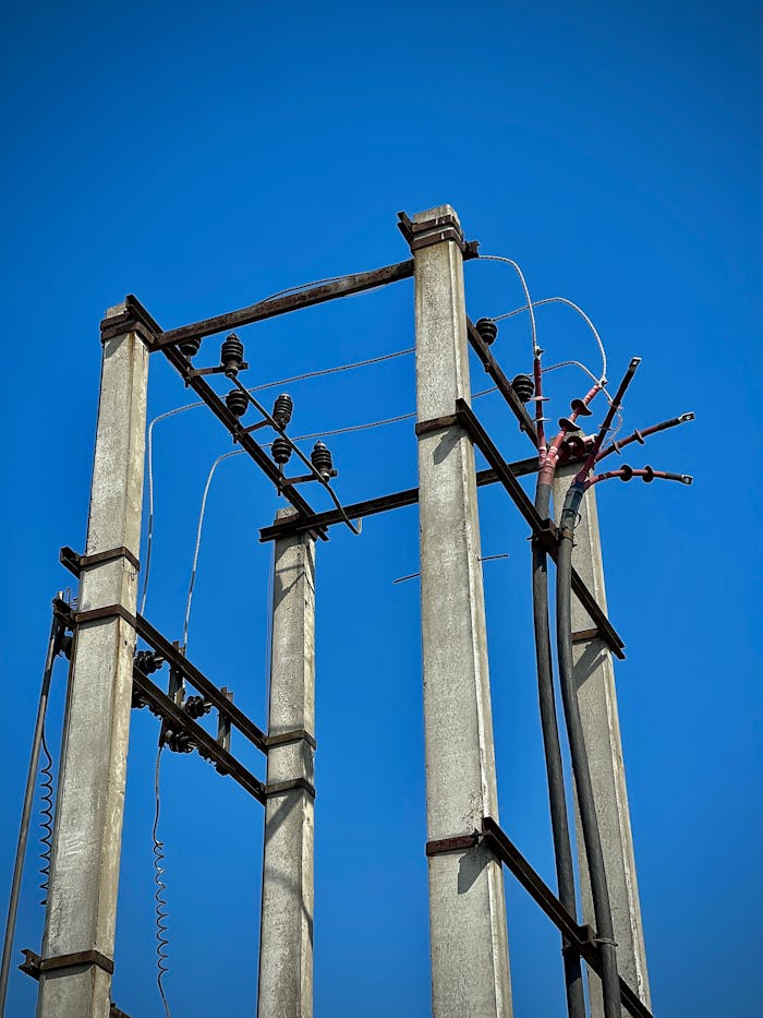 services-img High view of concrete utility poles and wires under a clear blue sky in Mohali, India.