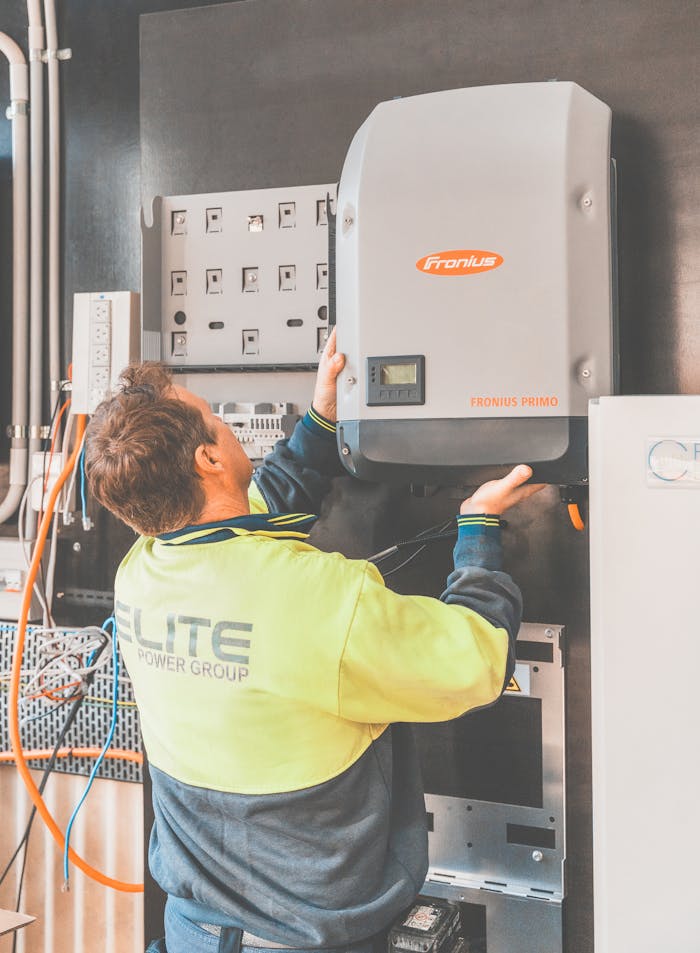 my-steps Expert technician setting up a solar inverter in Thornton, NSW, ensuring efficient solar energy flow.
